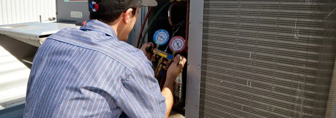 HVAC technician servicing a condenser unit in Goodlettsville