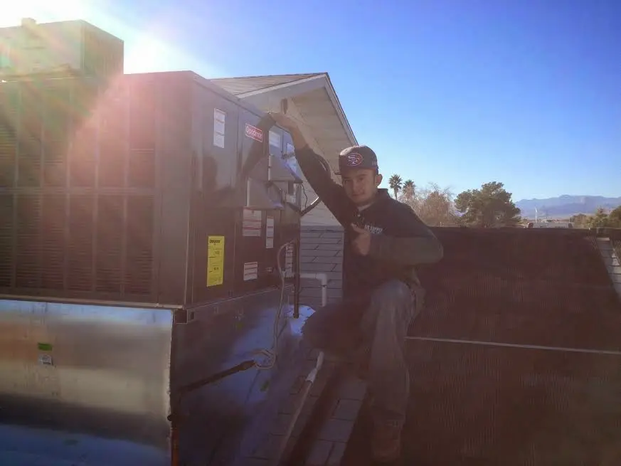 HVAC technician performing Boiler Repair on a rooftop unit in Goodlettsville